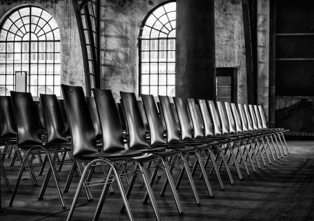 leere Stuhlreihen in einem alten Fabrikgebäude